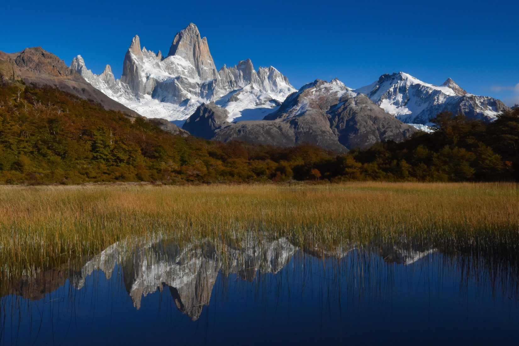 Mountain peaking above reflective lake