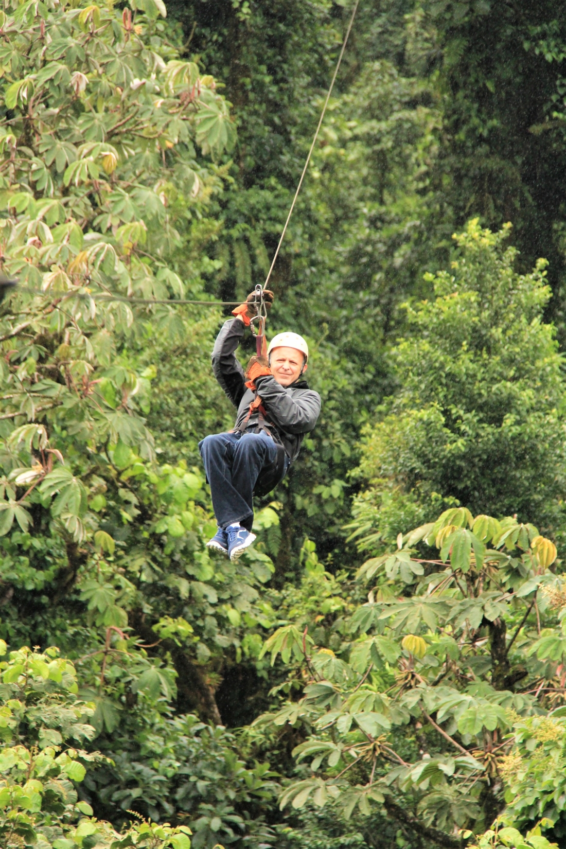 Man ziplining through cloud forest in Costa Rica